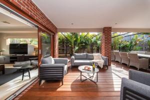 a living room with couches and chairs on a patio at Sorrento Serenity - Luxe Pet friendly with Pool in Sorrento