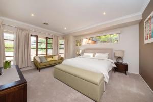 a bedroom with a large white bed and a couch at Sorrento Serenity - Luxe Pet friendly with Pool in Sorrento +36 photos