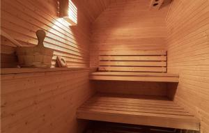 a wooden sauna with a wooden bench and a woodenigunigunigun at Awesome Home In Etne With Sauna in Etnesjøen