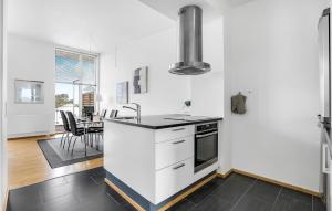 una cucina con mobili bianchi e un piano di lavoro nero di Apartment Nordre Havnevej Rømø V a Rømø Kirkeby Altre 15 foto