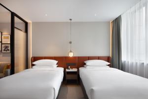 Voodi või voodid majutusasutuse Home2 Suite by Hilton Hangzhou Qianjiang New Town toas