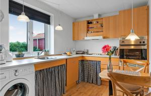 a kitchen with a washer and dryer at One-Bedroom Holiday Home In Ribe in Ribe +15 photos
