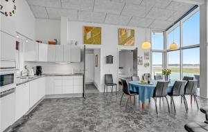 a kitchen and dining room with a table and chairs at Three-Bedroom Holiday Home In Skals in Skals