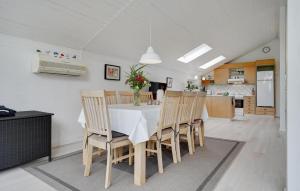 a kitchen and dining room with a table and chairs at Cozy Home In Glesborg With Wifi in Glesborg