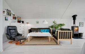 a living room with a couch and a table and chairs at Cozy Home In Glesborg With Wifi in Glesborg