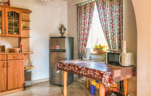 a kitchen with a table and a refrigerator at Holiday Home Orzysz Odoje in Orzysz