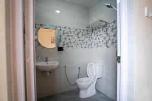 a bathroom with a toilet and a sink at Happiness Villa Pulau Ketam 幸福苑 in Kuala Selangor +14 photos