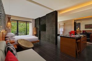 a hotel room with a bed and a kitchen at Renaissance Bali Uluwatu Resort & Spa in Uluwatu
