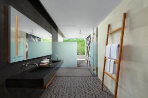 a bathroom with a black sink and a tub at Renaissance Bali Uluwatu Resort & Spa in Uluwatu