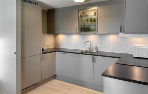 a kitchen with white cabinets and a sink at Cozy Apartment In Lillehammer With Wifi in Lillehammer