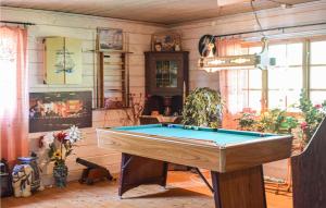a room with a pool table in it at Cozy Home In Holmsjö With Kitchen in Holmsjö