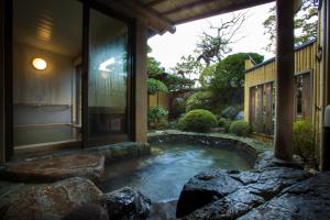a small pond in front of a house at Charoku Bekkan in Miyazu