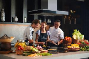 a group of three people preparing food in a kitchen at Renaissance Bali Uluwatu Resort & Spa in Uluwatu