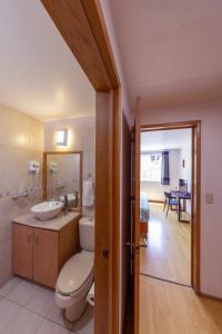 a bathroom with a toilet and a sink at Casa Hidalgo En El Corazón de Coyoacán in Mexico City