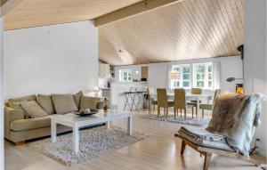 a living room with a couch and a table at Holiday Home Højby 9 in Lumsås