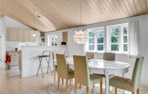 a kitchen and dining room with a table and chairs at Holiday Home Højby 9 in Lumsås