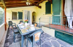 a blue table and chairs on a patio with a balcony at Gorgeous Home In Camaiore With Wifi in Camaiore