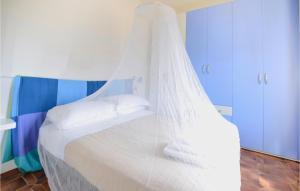 a white bed with a canopy in a room at Gorgeous Home In Camaiore With Wifi in Camaiore