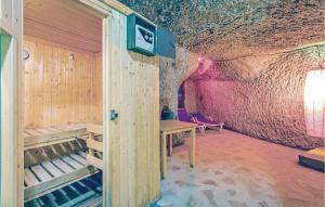 a room with a wooden wall and a table in a cave at Castello Rocchette in Celleno