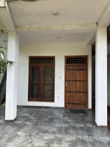 two wooden doors on a white house at 207 in Hikkaduwa +21 photos