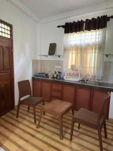 a kitchen with a table and chairs and a counter at 207 in Hikkaduwa
