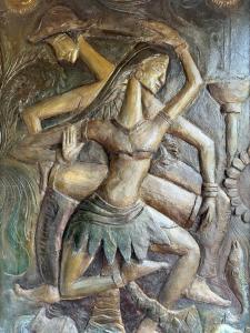 a wall painting of a woman playing a instrument at 207 in Hikkaduwa