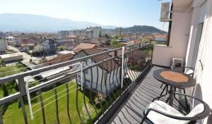 un balcon avec une table et une vue sur une ville dans l'établissement Vigilance Apartments, à Ohrid