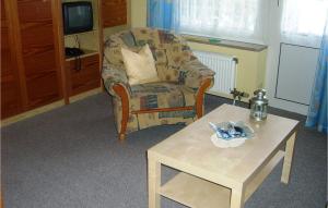 a living room with a chair and a coffee table at 1 Bedroom Amazing Apartment In Hohwacht in Hohwacht