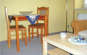 a living room with a table and chairs and a dining room at 1 Bedroom Amazing Apartment In Hohwacht in Hohwacht
