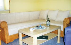 a living room with a couch and a coffee table at 1 Bedroom Amazing Apartment In Hohwacht in Hohwacht