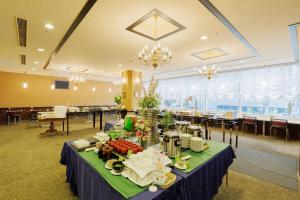 a table with food on it in a restaurant at Hotel Monte Hermana Sendai in Sendai
