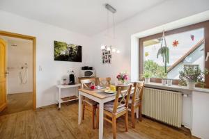 a kitchen and dining room with a table and chairs at Ferienwohnung Lilly in Eitelborn +19 photos