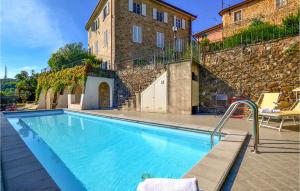 a large swimming pool in front of a building at Volpe in Camaiore
