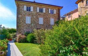 a large brick building with white shutters on it at Volpe in Camaiore