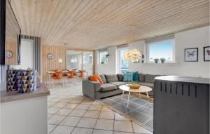 a living room with a couch and a table at Stunning Home In Ringkøbing With Sauna in Klegod