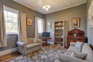 a living room with two chairs and a tv at Whites Corner in Bothwell