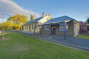 a yellow building on the side of a street at Whites Corner in Bothwell