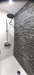 a bathroom with a stone wall and a shower at Queens Gardens Bliss in Paphos City +53 photos