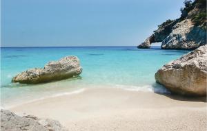 a beach with two large rocks in the water at Villa Antonietta in Oliena
