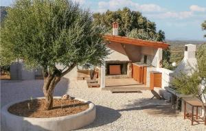 a house with a tree in the middle of a yard at Villa Antonietta in Oliena