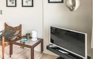 a living room with a large television and a table at Holiday Home Strandholmen Millinge V in Millinge +10 photos