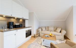 a living room with a couch and a table at Baltischer Hof Apartment 67 in Boltenhagen