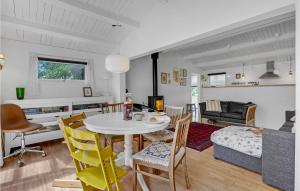 a dining room and living room with a table and chairs at Beautiful Home In Slagelse With Kitchen in Slagelse