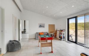a room with a ping pong table in it at Holiday Home Hvide Sande 25 in Bjerregård