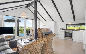 a living room with wicker chairs and a table at Holiday Home Teglbakken Egernsund I in Egernsund