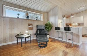 a room with a chair and a table and a kitchen at Holiday Home Egernsund With Patio 319 in Egernsund