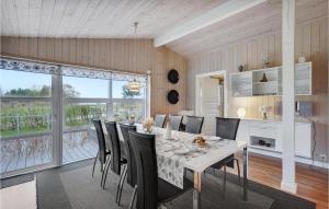 a dining room with a white table and chairs at Holiday Home Egernsund With Patio 319 in Egernsund