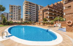 a swimming pool in an apartment with buildings in the background at Pet Friendly Apartment in Oropesa del Mar