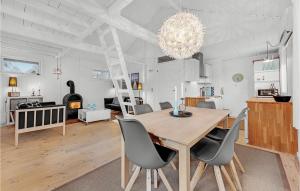 a dining room and living room with a table and chairs at Three-Bedroom Holiday Home In Sydals in Skovbyballe +17 photos