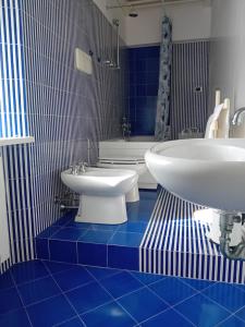 a blue and white bathroom with a sink and a toilet at La Liberty in Marciana Marina +37 photos